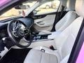 Interior of a 2020 Jaguar XE featuring a sleek dashboard leather seats and a modern steering wheel with a Jaguar logo