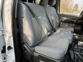 A 2015 Ford F-550 crew cab interior showing a gray bench seat with seatbelts and textured fabric upholstery