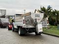 A 2021 Ford F600 truck featuring a dump bed with a Western brand spreader attached to the rear