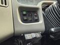 Close-up of the control panel in a 2013 International Durastar 4300 featuring buttons for lights mirrors and dashboard settings