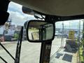 The image shows the interior mirror of a 2021 John Deere 1575 lawn tractor with visible controls and a steering wheel