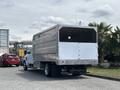 A 2020 Chevrolet Silverado truck with a large metal cargo box in the back, parked in a lot