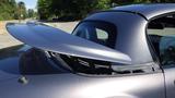 A 2007 Mazda Miata with a prominent rear wing and sleek body design showcasing its sporty features