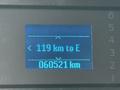 Digital display showing fuel range of 119 km to empty and odometer reading of 060521 km for a vehicle