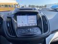 The dashboard of a 2016 Ford Escape featuring a touchscreen display with navigation options and audio controls