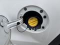 Close-up of a fuel cap on a 2016 GMC Sierra 1500 with a yellow label instructing to tighten until one click