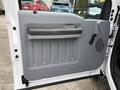 Interior door panel of a 2015 Ford F-350 SD featuring a gray finish and a handle for opening the door