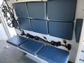 A 2013 Chevrolet Express with a row of blue padded seats secured with seatbelt anchors on the sidewall