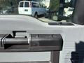 Close-up of the interior door handle and control buttons of a 2011 Ford F-550