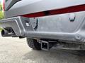 Close-up of the rear bumper and tow hitch receiver of a 2019 Ford F-150 with visible wiring and a rear exhaust pipe