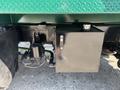 A black square fuel tank mounted on the side of a 2015 Peterbilt 337 truck with visible plumbing and valves attached