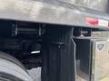 Close-up view of the rear section of a 2013 RAM 5500 featuring a black textured surface and a chrome exhaust tip with a blue sticker indicating work truck status