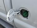 Close-up of the fuel cap on a 2008 Ford F-250 SD revealing the fuel nozzle inside the cap opening