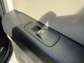 A close-up of the door panel switch for a 2018 Ford F-150 featuring a textured black surface and a rectangular button