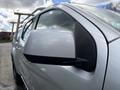 A silver 2018 Chevrolet Colorado with a focus on the side mirror and part of the truck's body