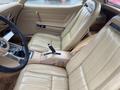 Interior of a 1970 Chevrolet Corvette featuring light tan leather seats and a gear shift on the center console