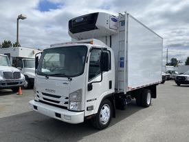 A white 2019 Isuzu NRR refrigerated truck with a boxy cargo area and front air conditioning unit parked in a lot