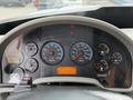 The dashboard of a 2012 International TerraStar featuring multiple analog gauges for RPM speed fuel water and air pressure along with a digital display