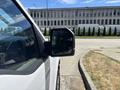 A 2019 Ford F-150 viewed from the side focusing on the driver's side mirror and part of the truck's exterior