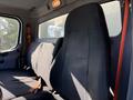 Interior of a 2012 Freightliner M2 106 featuring a driver's seat with a seatbelt and a passenger seat both in black fabric