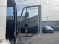 A 2020 Lion Lion6 truck with the driver's side door open showcasing the interior panel and control features