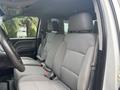 Interior view of a 2016 GMC Sierra 1500 showing two front seats with gray fabric upholstery and a steering wheel