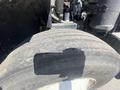 A close-up view of a worn tire on a 1997 Freightliner FL70 showing visible tread wear and surface details