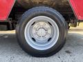 A close-up of a silver aluminum wheel with a six-bolt pattern and a large black tire marked Continental 22570 R19.5