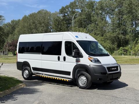 A 2021 RAM Promaster van with a white exterior and black windows parked on a road