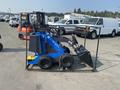 A blue 2025 AGT MX-MZW14 compact tool carrier with a small bucket attachment and four wheels enclosed in a metal frame