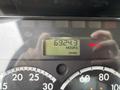 A close-up of a vehicle's dashboard display showing 6924.3 hours on the engine with various gauge readings and a brake alert illumination