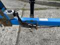 A worn blue and rusted Genie TZ-34/20 lift with visible cables and hydraulic components in a close-up view