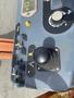 Control panel of a 2009 JLG E300AJP featuring various switches buttons and a joystick for movement and operation