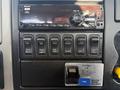 Dashboard controls of a 2017 International 4300 featuring a radio and various switches for functions like exhaust brake fog lights and differential lock