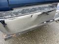 Close-up of the chrome rear bumper of a 2006 Dodge Ram 2500 showing signs of wear and scratches