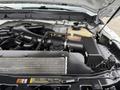 Engine compartment of a 2016 Ford F-550 Super Duty showcasing the engine components and various hoses and tanks