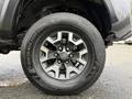 Close-up view of a 2016 Toyota Tacoma wheel featuring a silver alloy rim and a Kumho tire with a rugged tread design
