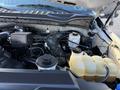 A 2020 Ford F-350 engine bay showcasing various components including a coolant reservoir battery and electrical connections