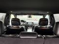 Interior view of a 2019 Jeep Grand Cherokee showcasing dark leather seats and a central dashboard with controls and infotainment system visible
