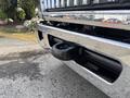 A close-up view of the chrome front bumper of a 2013 International WorkStar with a visible tow hook attached