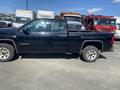 A black 2014 GMC Sierra 1500 truck with a spacious cabin and cargo bed parked on a lot