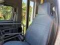 A gray vinyl driver's seat inside a 2013 Ford Econoline with a metal frame next to it