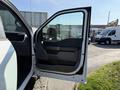 A 2021 Ford F-150 with the driver's side door open showcasing the interior and door panel details