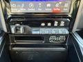 The interior controls of a 2023 RAM 3500 featuring buttons for towing and auxiliary functions along with a touchscreen display for vehicle settings