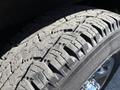 Close-up of a tire on a 2019 GMC Savana showcasing deep tread patterns and texture with visible dirt and wear marks