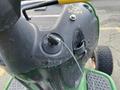 Close-up of the control panel of a 2021 John Deere L Series S lawn mower featuring the ignition key switch and starter pull cord mechanism