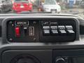 Dashboard controls of a 2017 Ford Econoline featuring switches for arrow, lift, and auxiliary lights