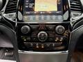 Close-up view of the interior control panel of a 2019 Jeep Grand Cherokee featuring various buttons and a touchscreen display for navigation and audio settings