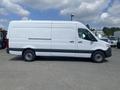 A 2025 Mercedes-Benz Sprinter van in white with a high roof and sliding side door, positioned sideways with a plain design and no visible branding