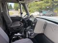 Interior view of a 2013 International WorkStar showing the driver's seat dashboard controls and steering wheel with visible wiring and a cup holder